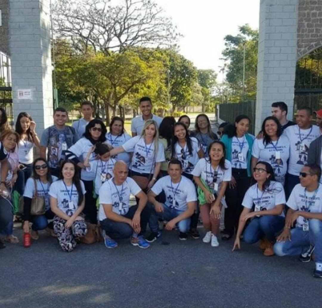 Peregrinos com a camiseta oficial reunidos no portão de acesso à Canção Nova